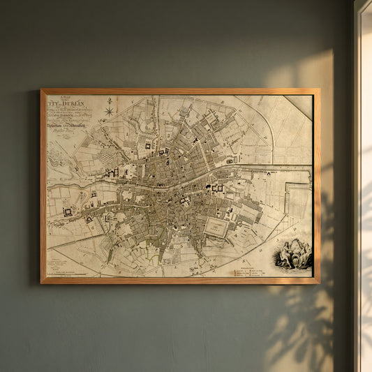 1797 Dublin Map framed print in a natural oak frame on a dark green wall beside a window, dappled plant shadow