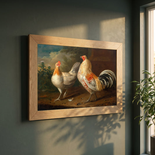 A Sporting Cockerel and Hen framed print in a natural oak frame on a dark green wall beside a window, dappled plant shadow