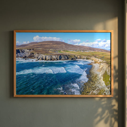 Achill Island Framed Print | Wild Atlantic Way, Co. Mayo framed print in a natural oak frame on a dark green wall beside a window, dappled plant shadow