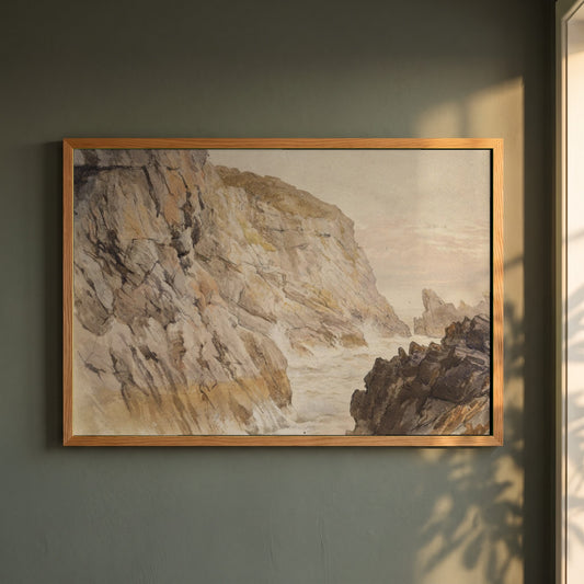 Cliffs at Howth, Dublin framed print in a natural oak frame on a dark green wall beside a window, dappled plant shadow
