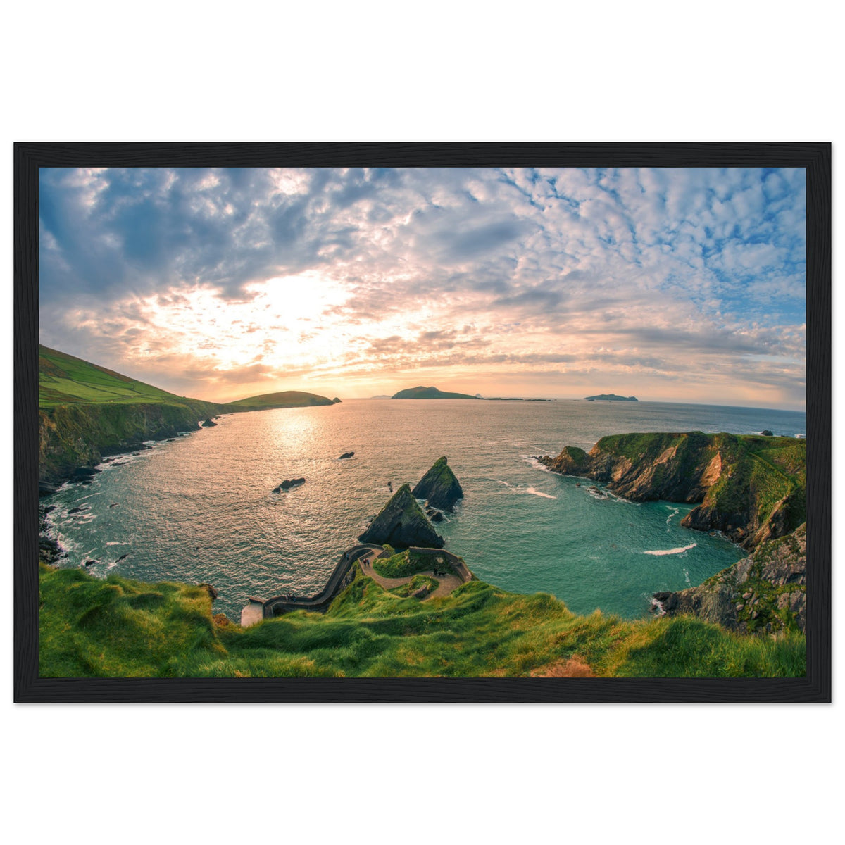 Framed Dingle Peninsula print in a wide black frame, sunset sky over islands, sea cliffs and green headland