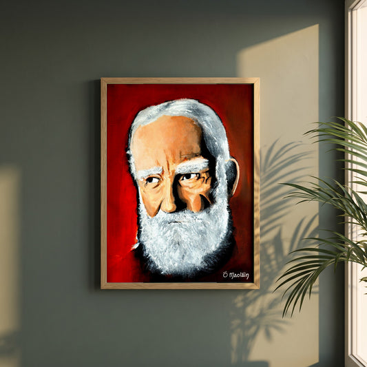 George Bernard Shaw Irish Writer framed print in a natural oak frame on a dark green wall beside a window, dappled plant shadow