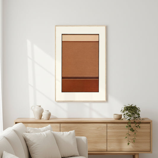 Gradated Tones of Broken Red framed print in an oak frame above a sideboard behind a white sofa