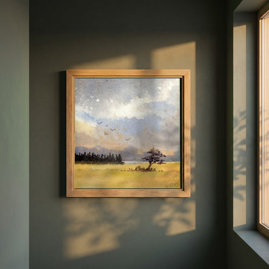 Landscape with Tree Silhouette framed print in a natural oak frame on a dark green wall beside a window, dappled plant shadow