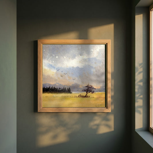 Landscape with Tree Silhouette framed print in a natural oak frame on a dark green wall beside a window, dappled plant shadow