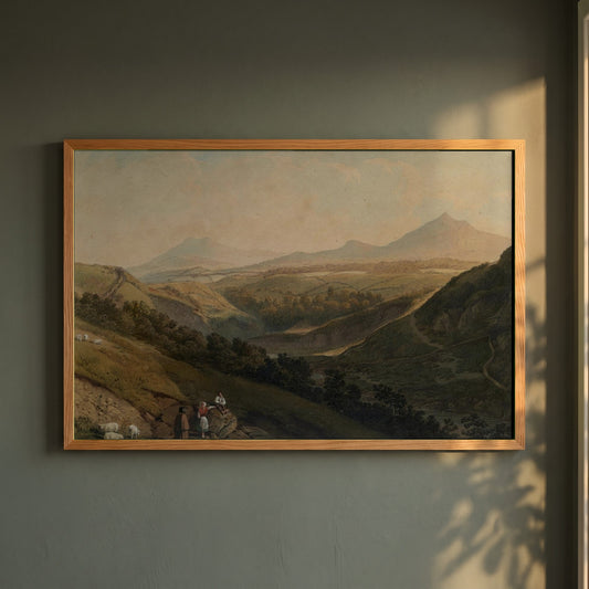 Little & Great Sugar Loaf framed print in a natural oak frame on a dark green wall beside a window, dappled plant shadow