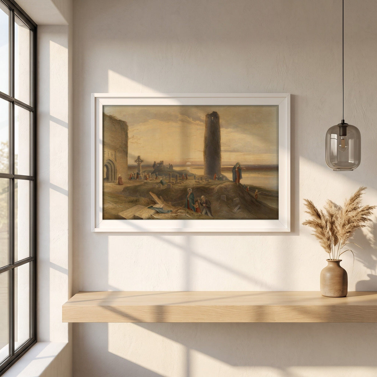 The Last Circuit of Pilgrims at Clonmacnoise by George Petrie framed print in a white frame on a plaster wall above an oak worktop in a bright Scandinavian kitchen