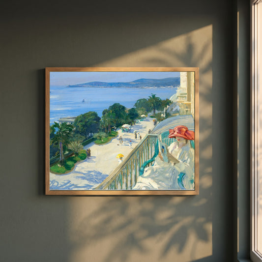 The Terrace, Cap d'Ail framed print in a natural oak frame on a dark green wall beside a window, dappled plant shadow