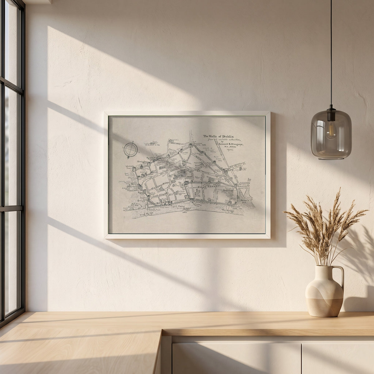 The Walls of Dublin framed print in a white frame on a plaster wall above an oak worktop in a bright Scandinavian kitchen
