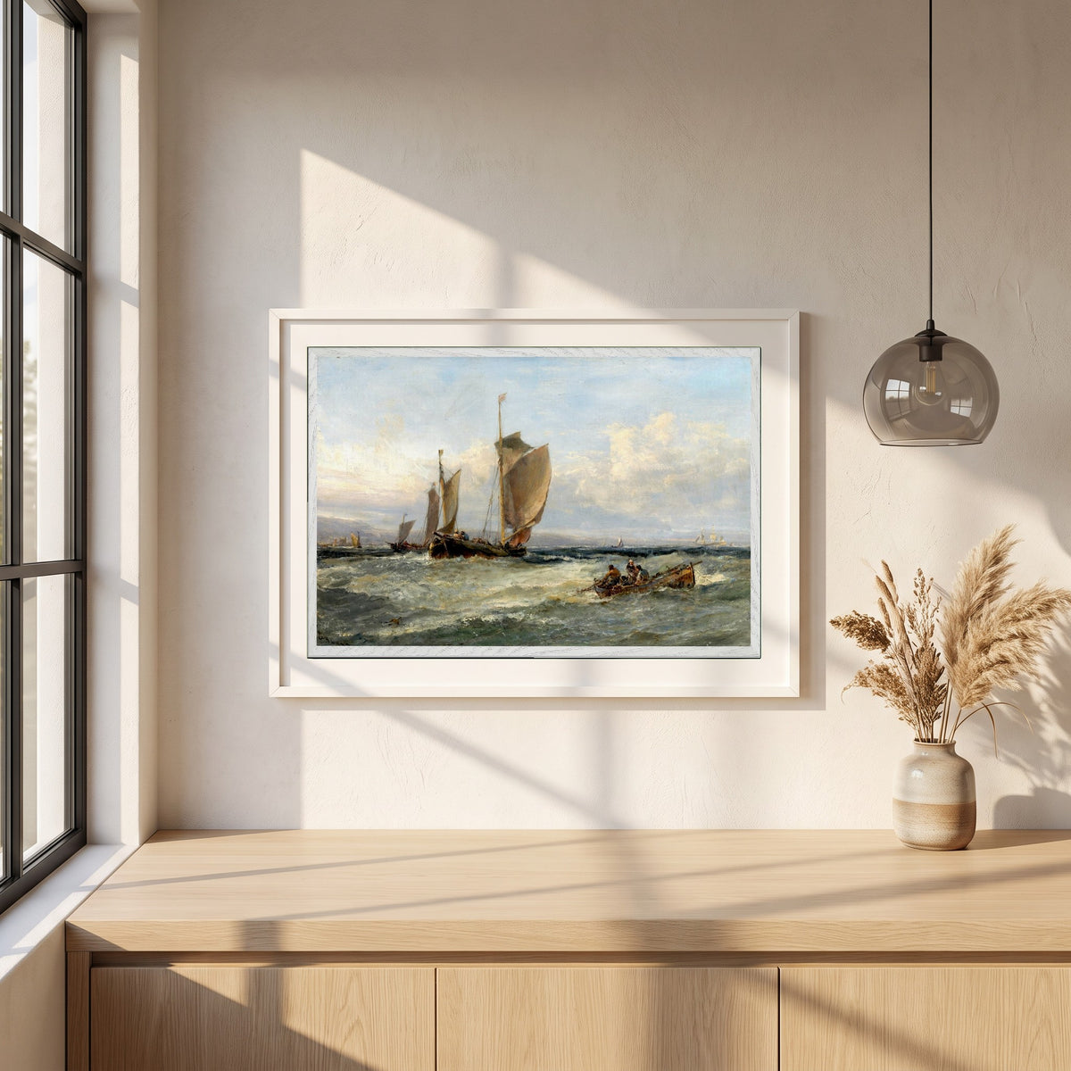 Trawlers Leaving Port framed print in a white frame on a plaster wall above an oak worktop in a bright Scandinavian kitchen