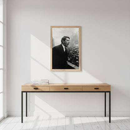 Black-framed Michael Collins print above a sleek oak desk, white walls, matte black accents, books stacked neatly, sunlight casting soft shadows
