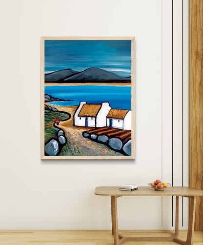 Framed art print titled Connemara Lakes Cottage" by Irish artist Ó Maoláin. Features a serene lakeside cottage in Connemara's picturesque countryside, capturing Ireland's rustic beauty with rolling hills, tranquil waters, and vibrant colours.