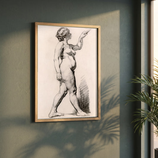 A Standing Female Figure framed print in a natural oak frame on a dark green wall beside a window, dappled plant shadow