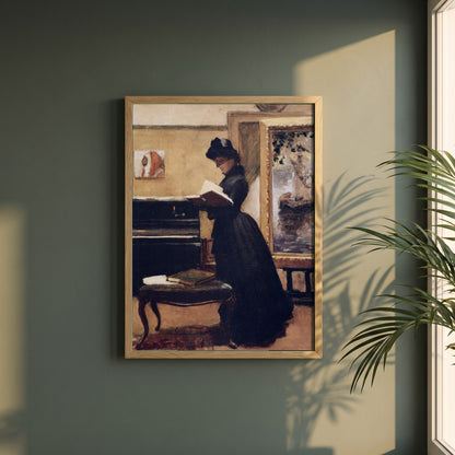 A Visit to the Studio framed print in a natural oak frame on a dark green wall beside a window, dappled plant shadow