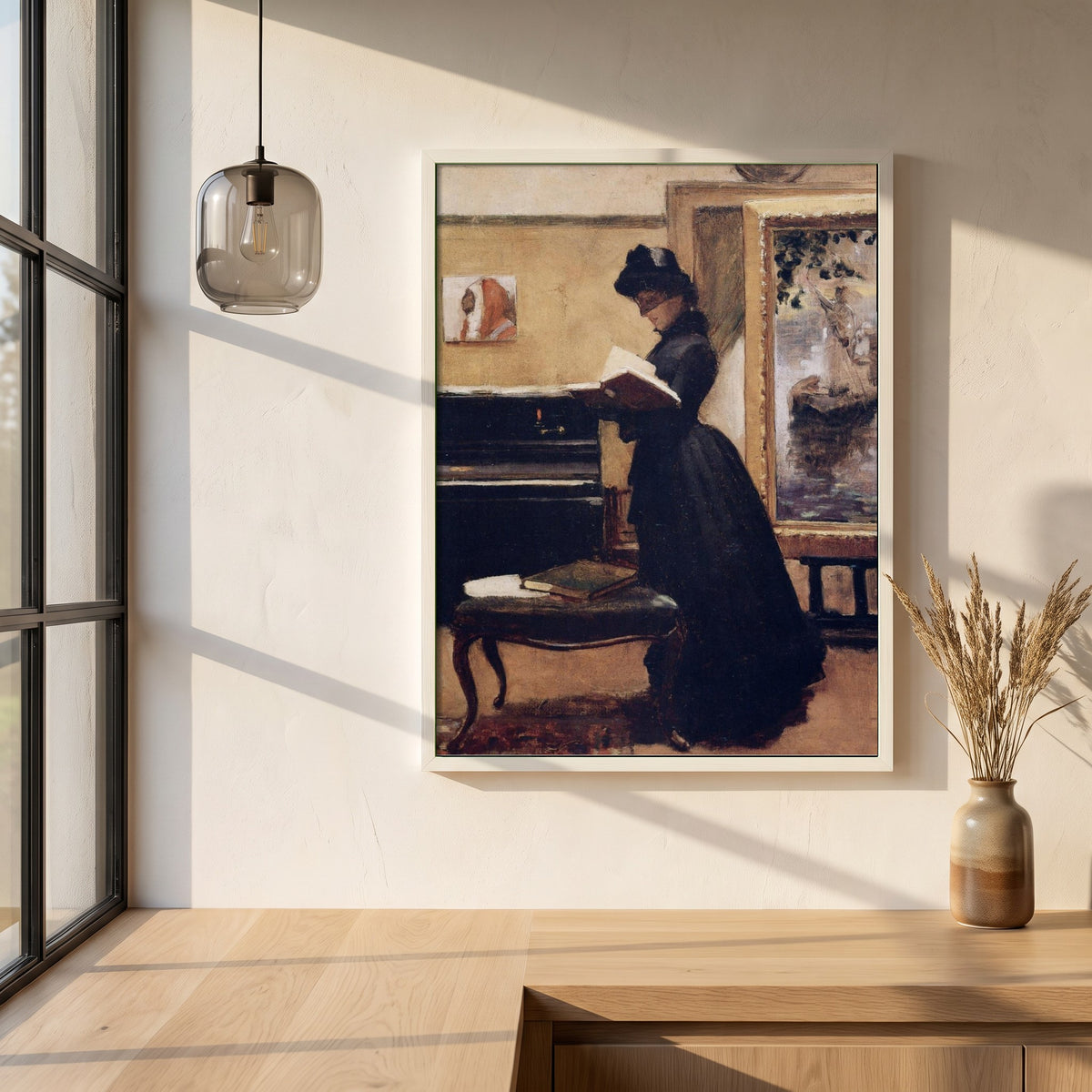 A Visit to the Studio framed print in a white frame on a plaster wall above an oak worktop in a bright Scandinavian kitchen