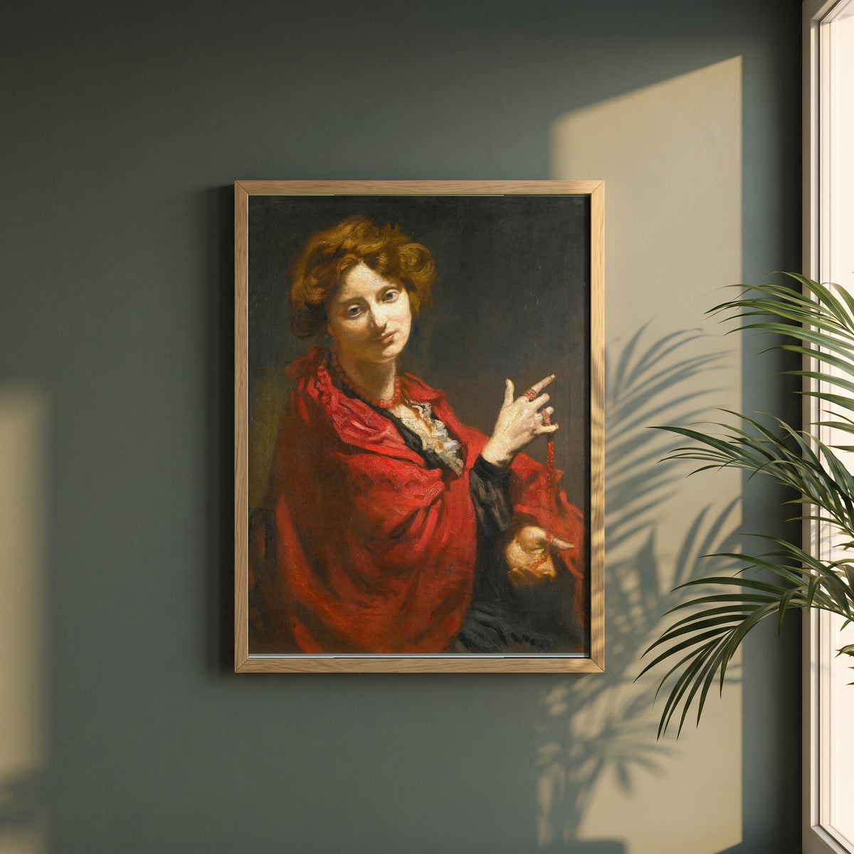 Anita Bartle, The Red Shawl framed print in a natural oak frame on a dark green wall beside a window, dappled plant shadow