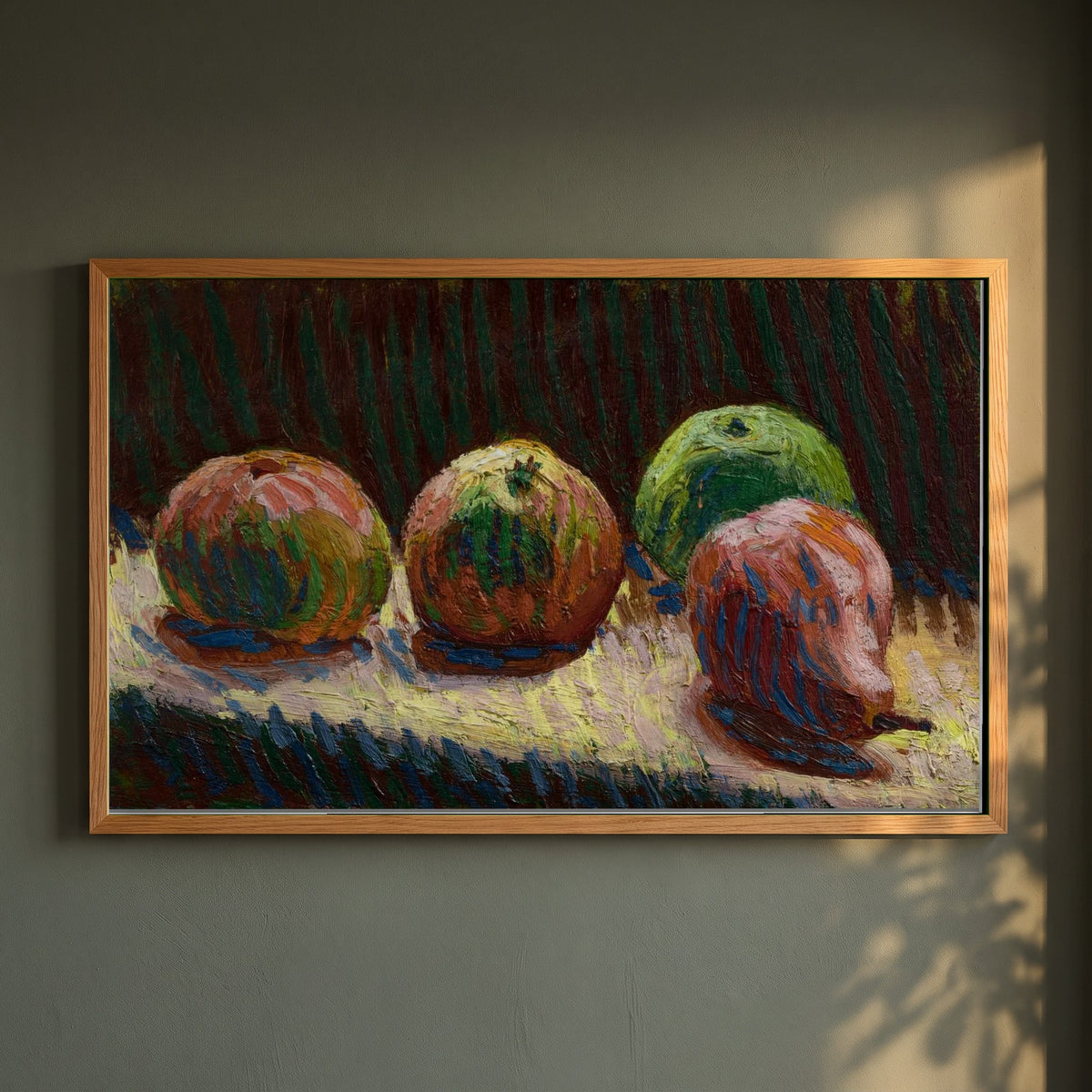 Apples and Pear Roderic O'Conor framed print in a natural oak frame on a dark green wall beside a window, dappled plant shadow
