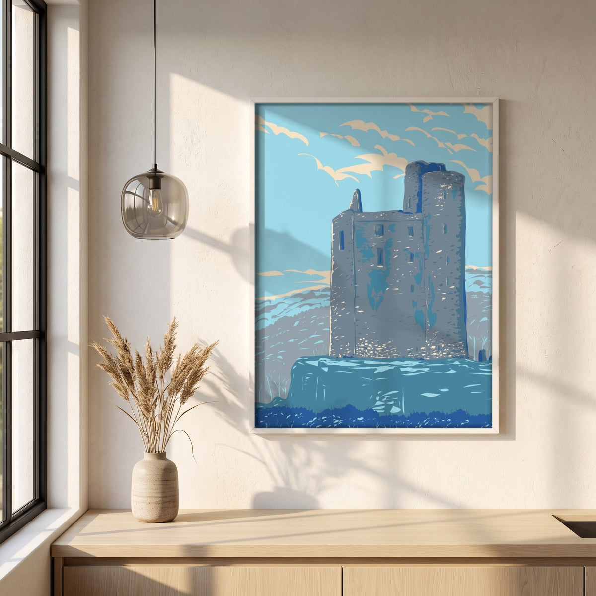 Ballinalacken Castle, County Clare retro travel print in a white frame on a plaster wall above an oak worktop in a bright Scandinavian kitchen