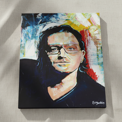 Bono U2 portrait print shown at an angle on a linen surface, bold blue, red and yellow brushwork