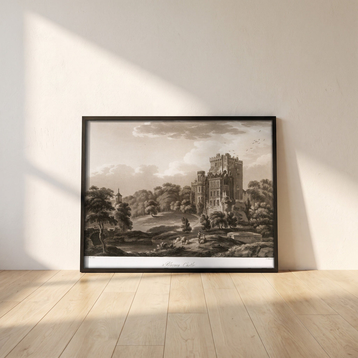 Blarney Castle 1796 by Thomas Sautelle Roberts Art Print framed print in a black frame leaning against a white plaster wall on oak floorboards in morning light