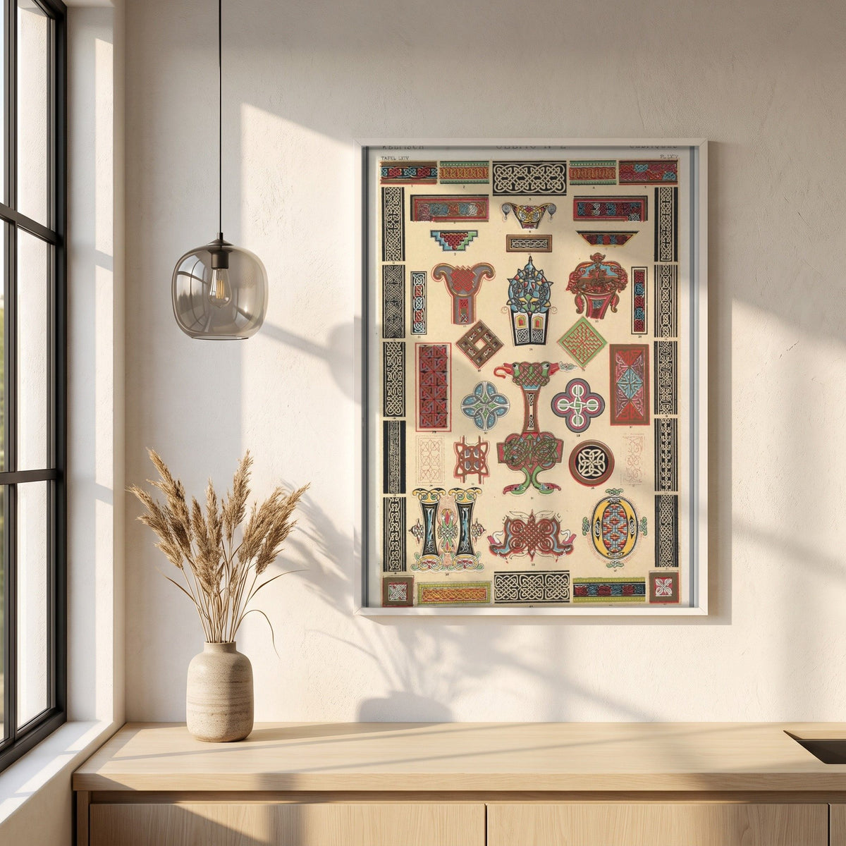 Celtic No.2 by Owen Jones framed print in a white frame on a plaster wall above an oak worktop in a bright Scandinavian kitchen