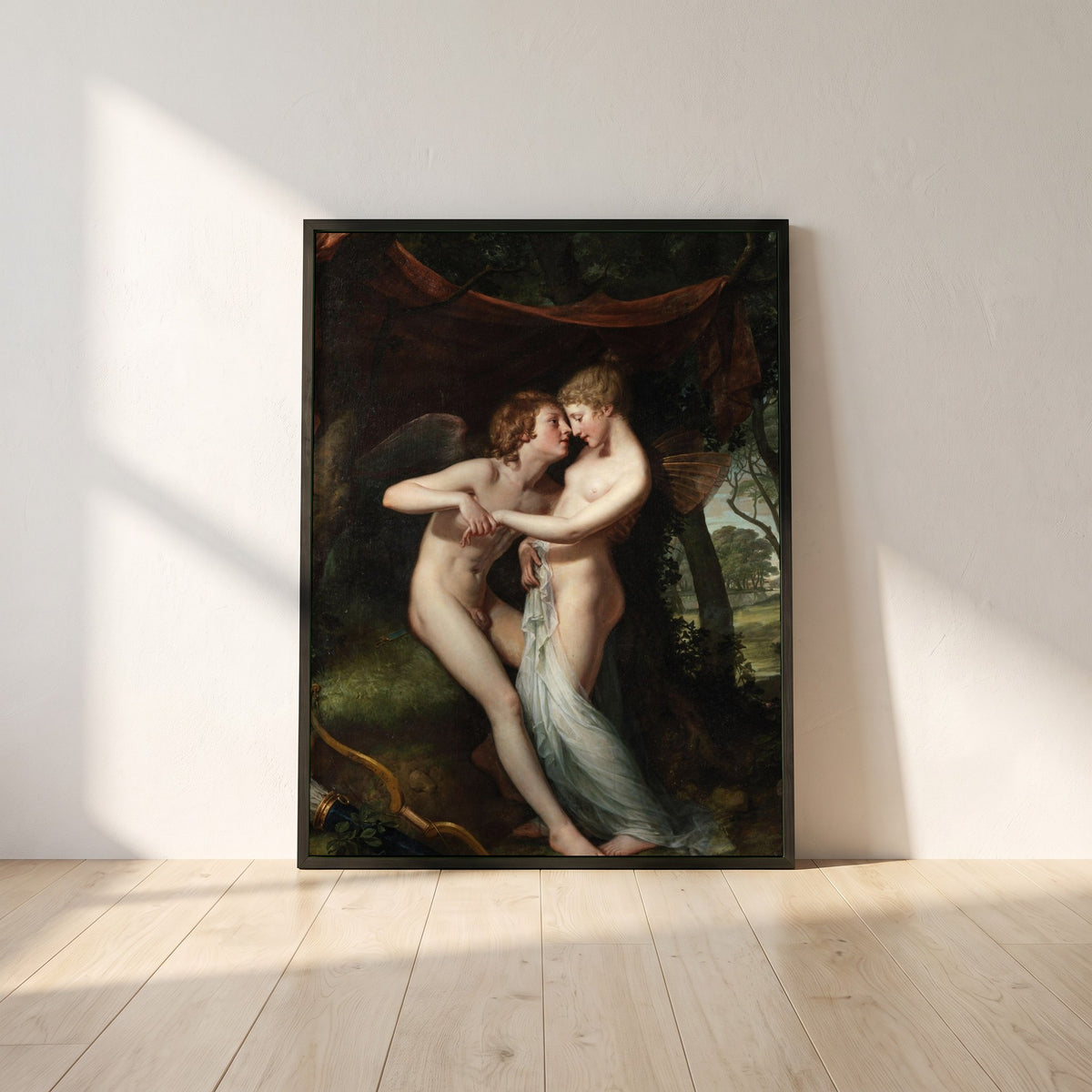 Cupid and Psyche framed print in a black frame leaning against a white plaster wall on oak floorboards in morning light