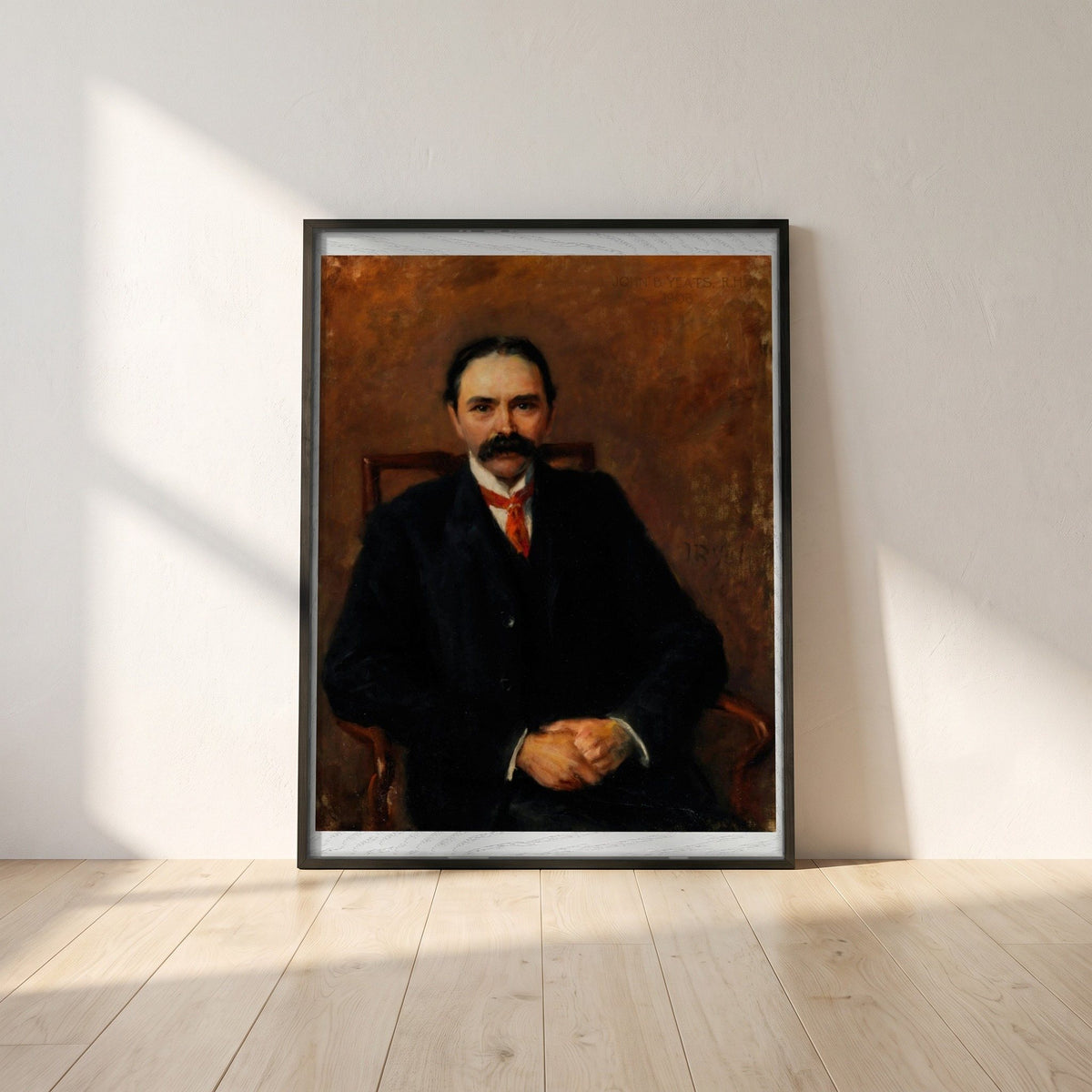 Douglas Hyde framed print in a black frame leaning against a white plaster wall on oak floorboards in morning light