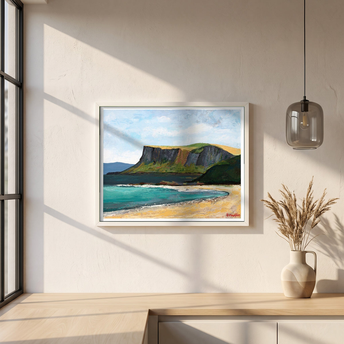 Fair Head from Ballycastle Beach framed print in a white frame on a plaster wall above an oak worktop in a bright Scandinavian kitchen