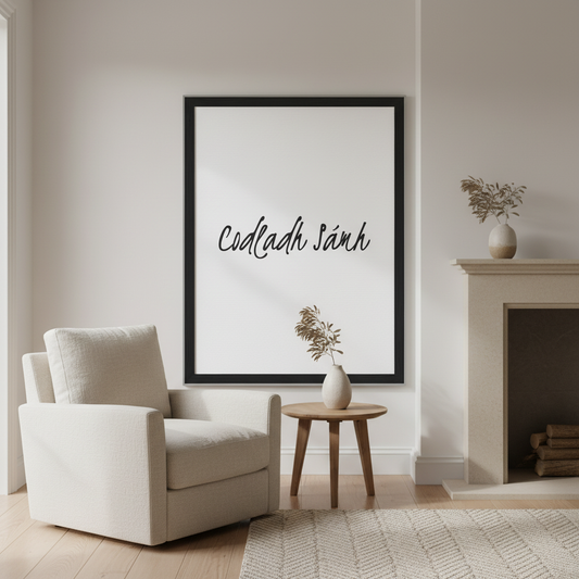 Codladh Sámh Sleep Well Irish language print in a black frame above an armchair beside a fireplace