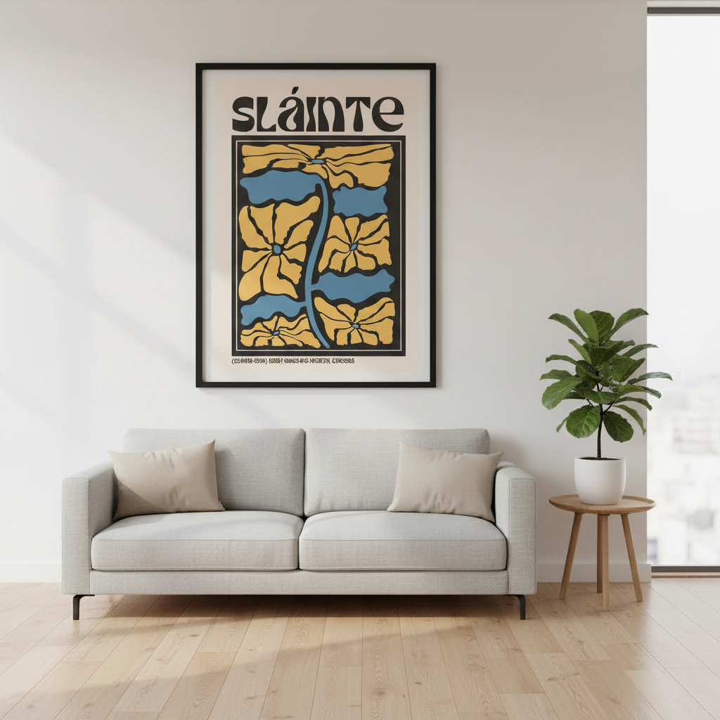 Sláinte Irish cheers print in a black frame above a grey sofa and potted plant in a bright room