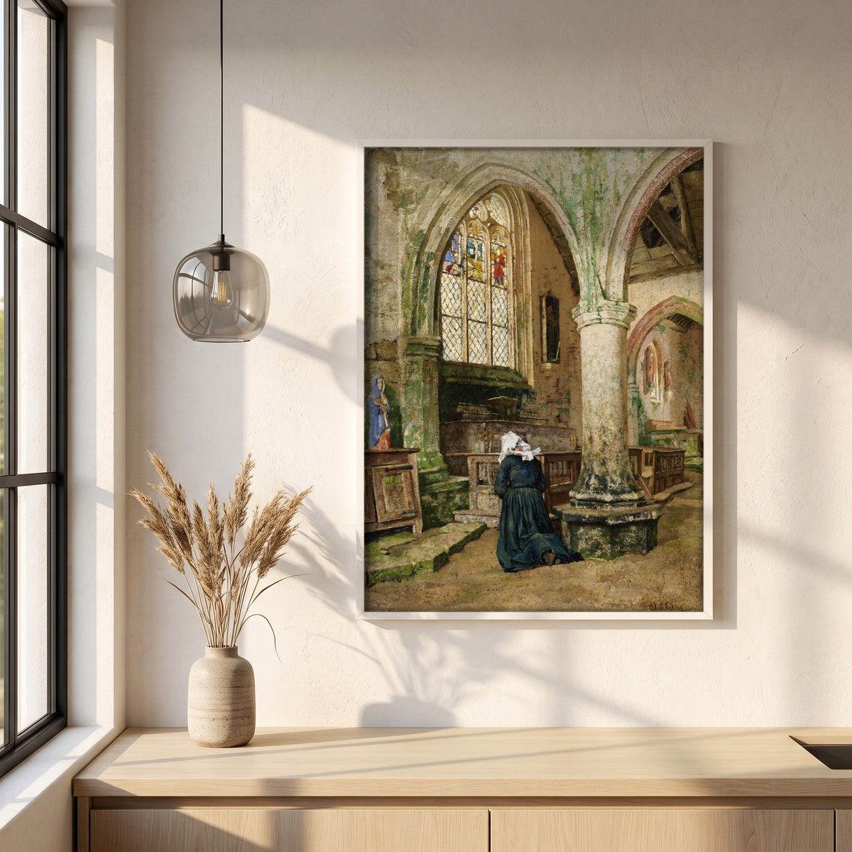 Interior of a Church in Brittany framed print in a white frame on a plaster wall above an oak worktop in a bright Scandinavian kitchen