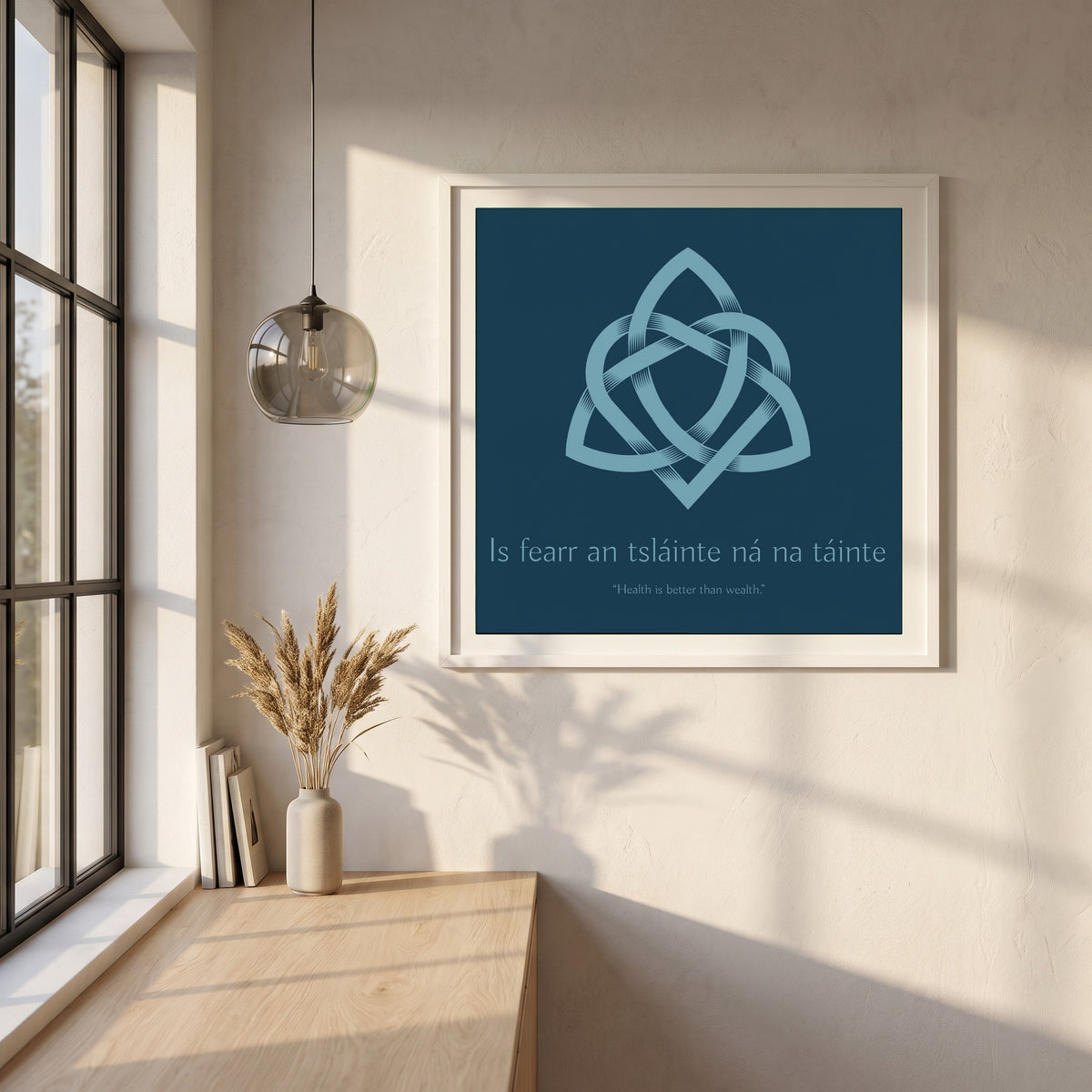 Is fearr an tsláinte ná na táinte framed print in a white frame on a plaster wall above an oak worktop in a bright Scandinavian kitchen