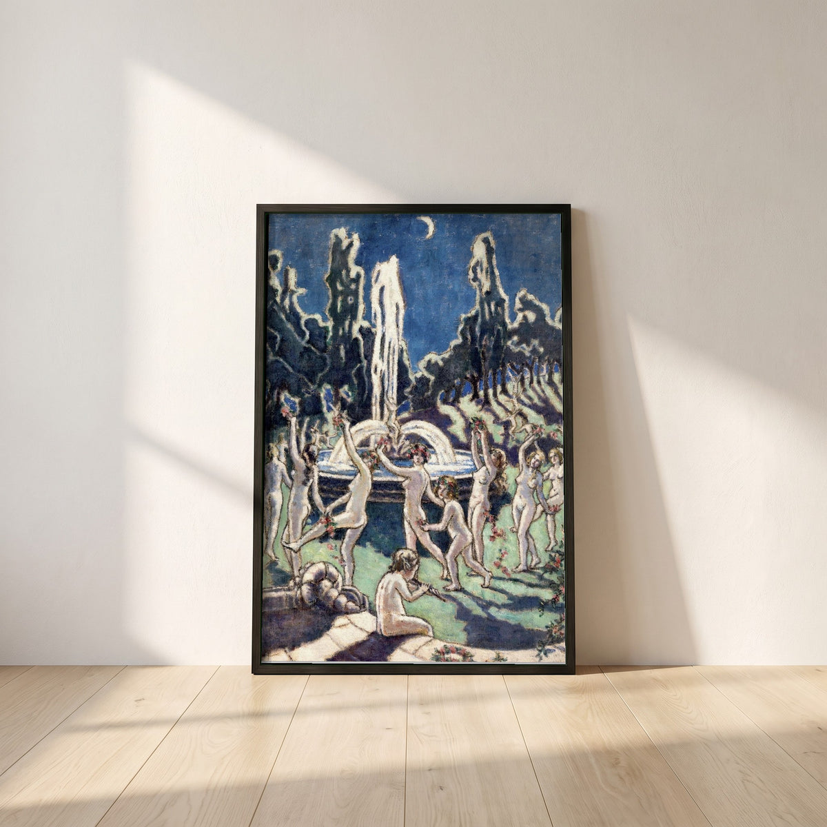 Figures Dancing Round a Fountain framed print in a black frame leaning against a white plaster wall on oak floorboards in morning light