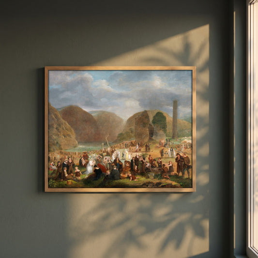 Patron's Day at the Seven Churches, Glendalough (c.1816) framed print in a natural oak frame on a dark green wall beside a window, dappled plant shadow