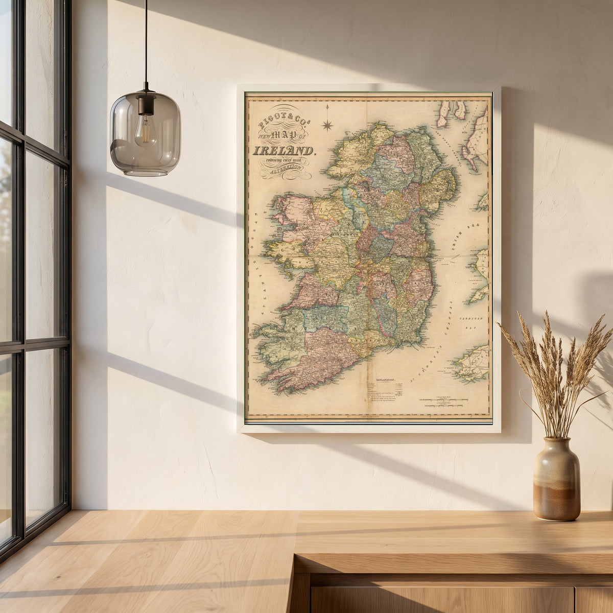 Map of Ireland framed print in a white frame on a plaster wall above an oak worktop in a bright Scandinavian kitchen