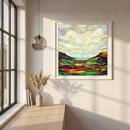 Glenariff framed print in a white frame on a plaster wall above an oak worktop in a bright Scandinavian kitchen