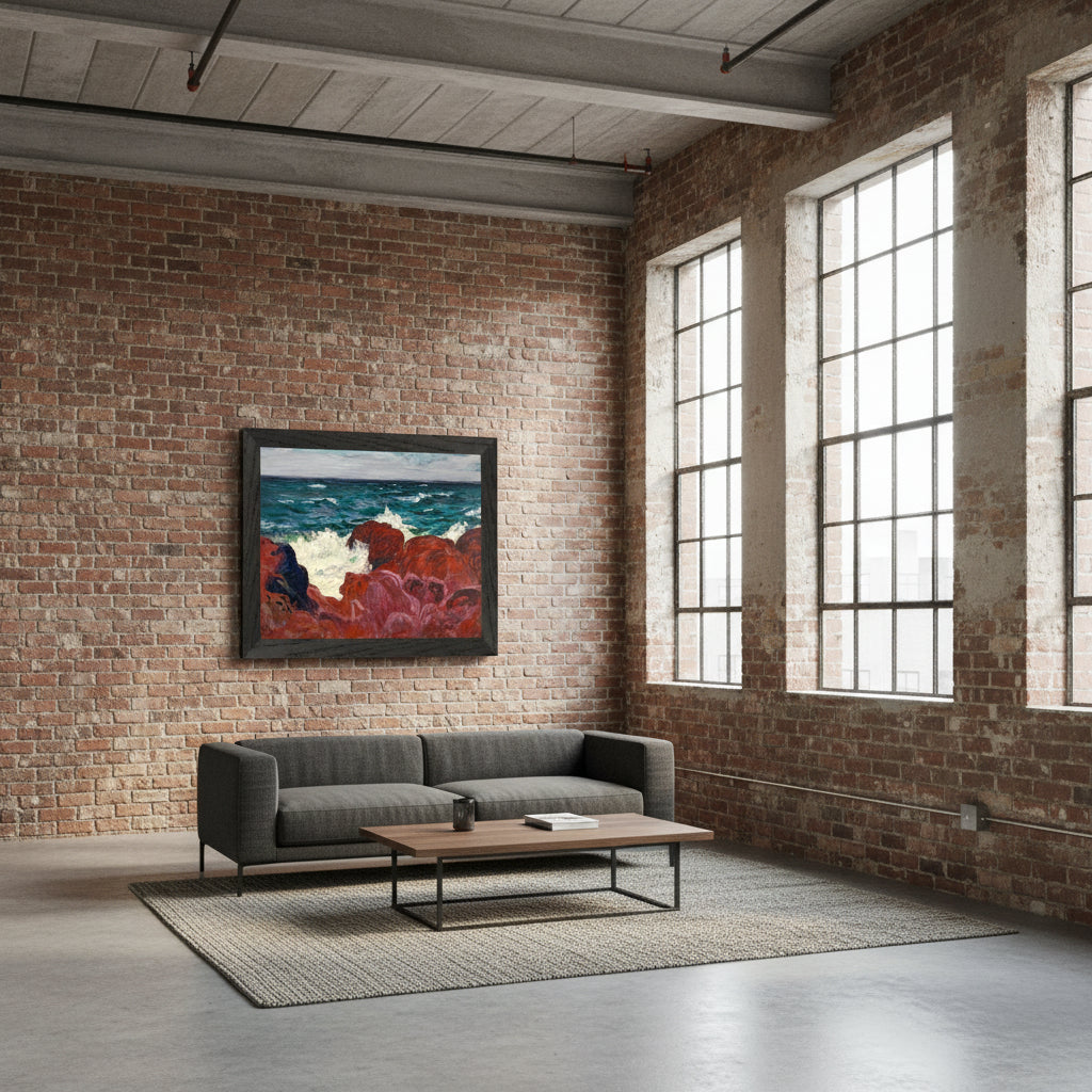 Red Rocks and Sea framed print in a black frame on an exposed brick wall above a grey sofa in a loft