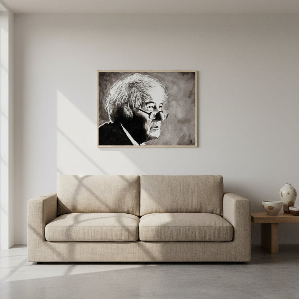 Seamus Heaney portrait framed print in an oak frame above a beige sofa in a pale room