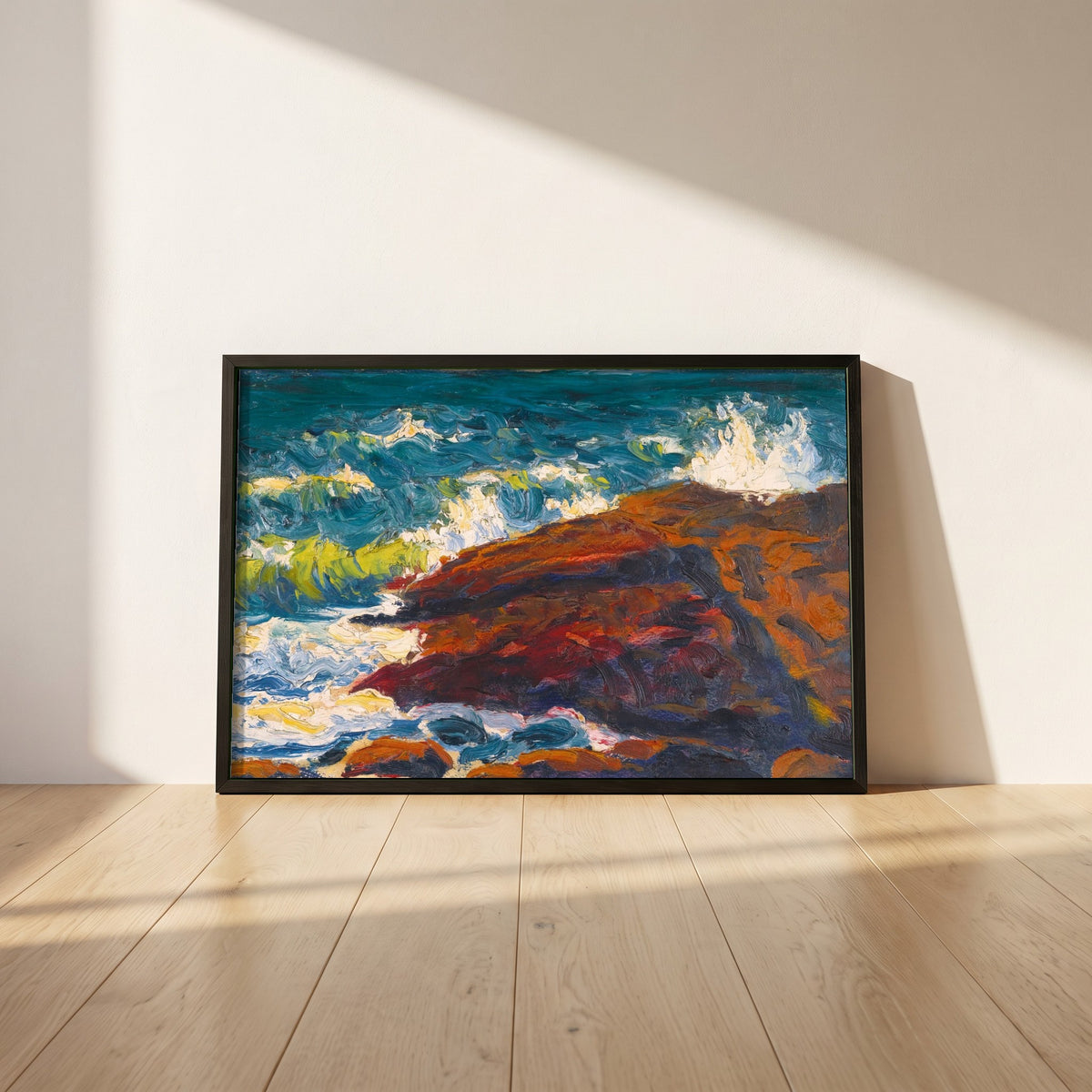 Seascape framed print in a black frame leaning against a white plaster wall on oak floorboards in morning light