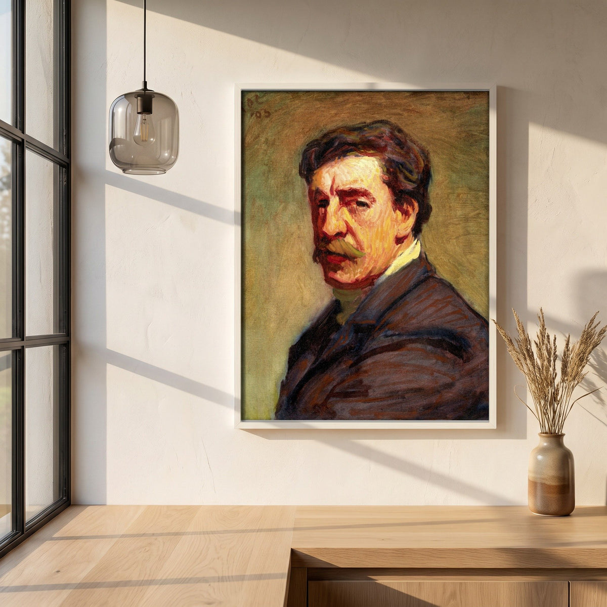 Self-Portrait (1903) by Roderic O'Conor framed print in a white frame on a plaster wall above an oak worktop in a bright Scandinavian kitchen
