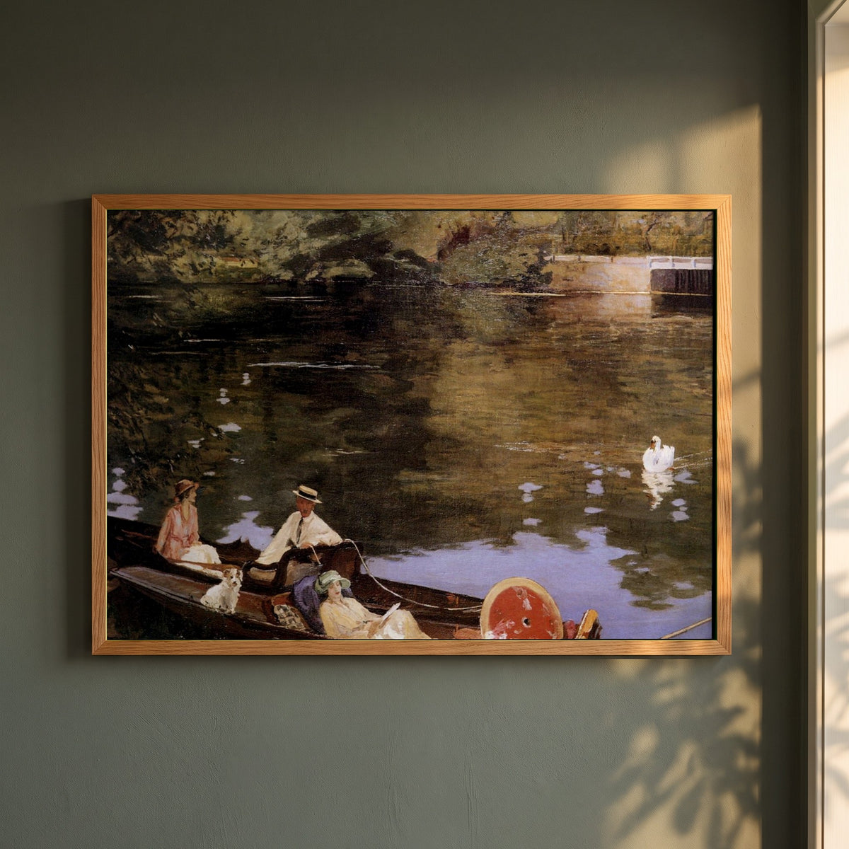 Sutton Courtenay framed print in a natural oak frame on a dark green wall beside a window, dappled plant shadow