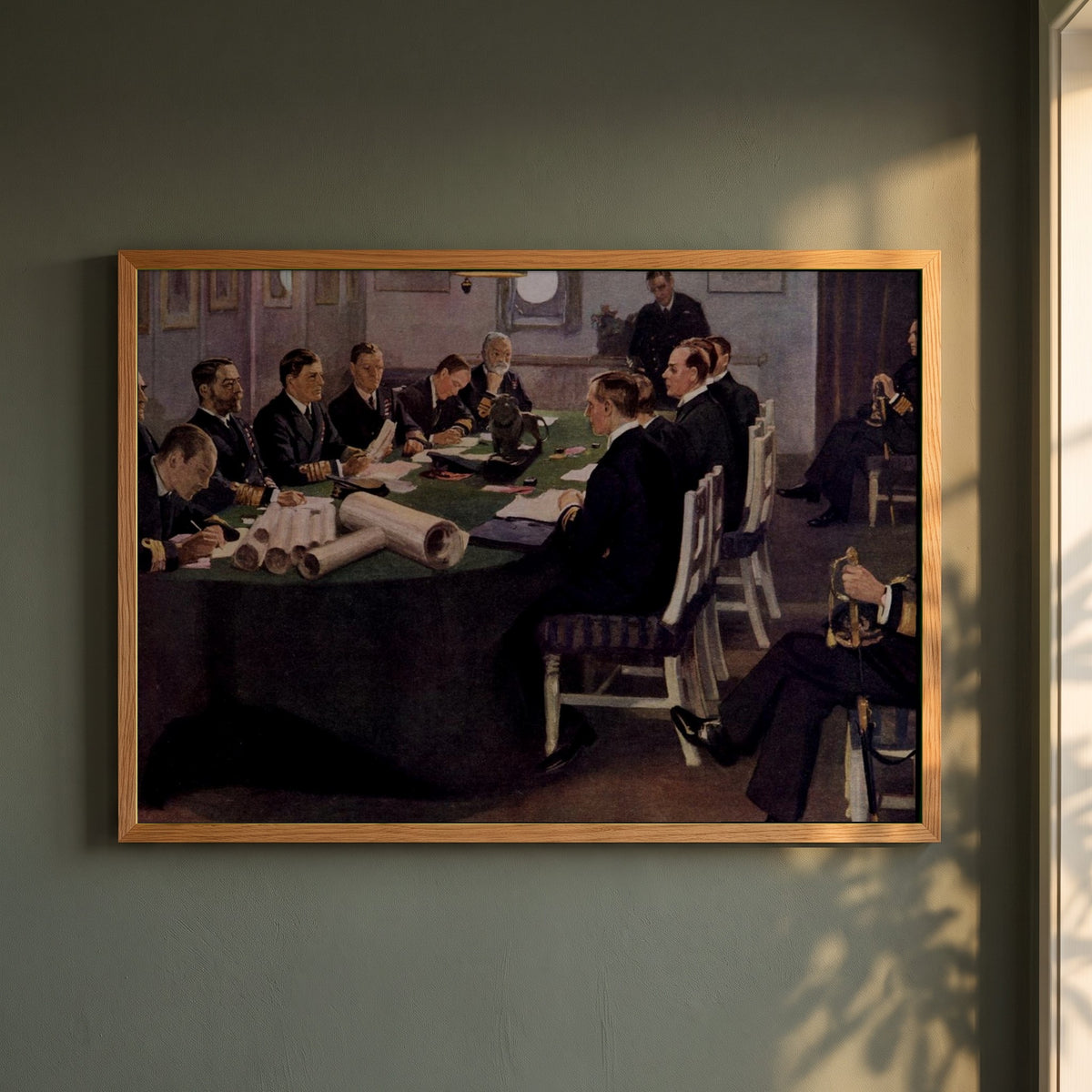 Admiral Sir David Beatty Reading the Terms of the Armistice framed print in a natural oak frame on a dark green wall beside a window, dappled plant shadow