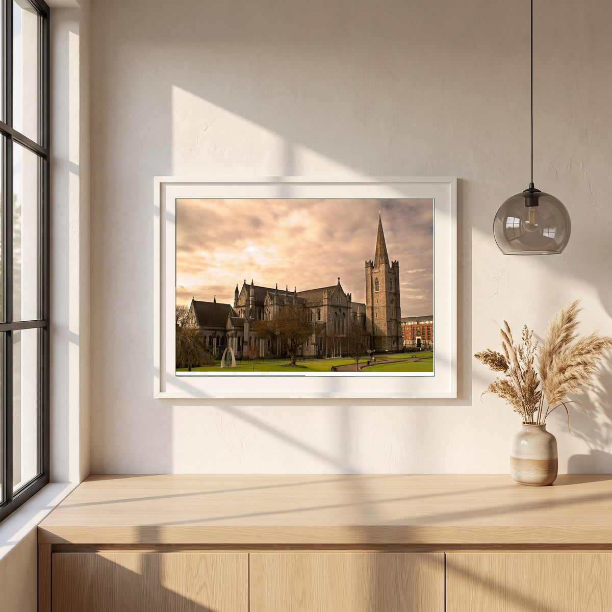 St. Patrick's Cathedral Dublin framed print in a white frame on a plaster wall above an oak worktop in a bright Scandinavian kitchen