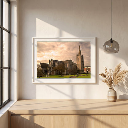 St. Patrick's Cathedral Dublin framed print in a white frame on a plaster wall above an oak worktop in a bright Scandinavian kitchen