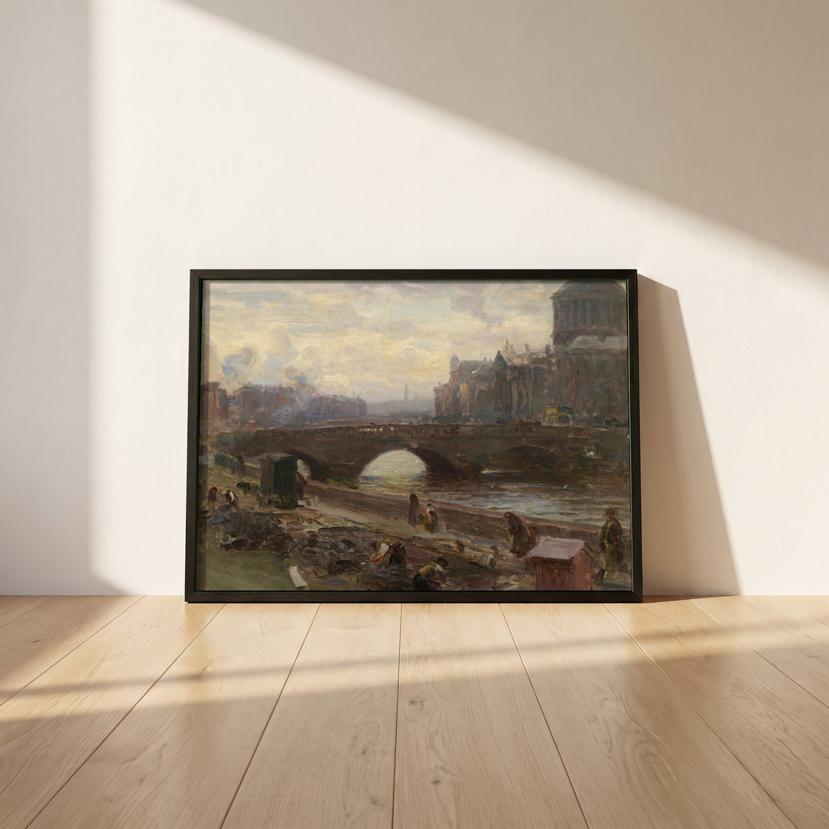 The Four Courts, Dublin framed print in a black frame leaning against a white plaster wall on oak floorboards in morning light
