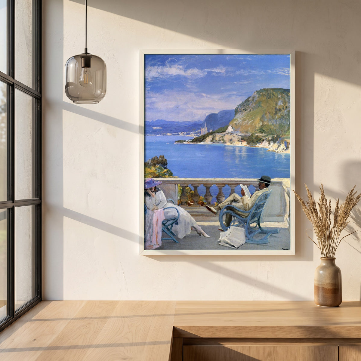 The Honeymoon framed print in a white frame on a plaster wall above an oak worktop in a bright Scandinavian kitchen