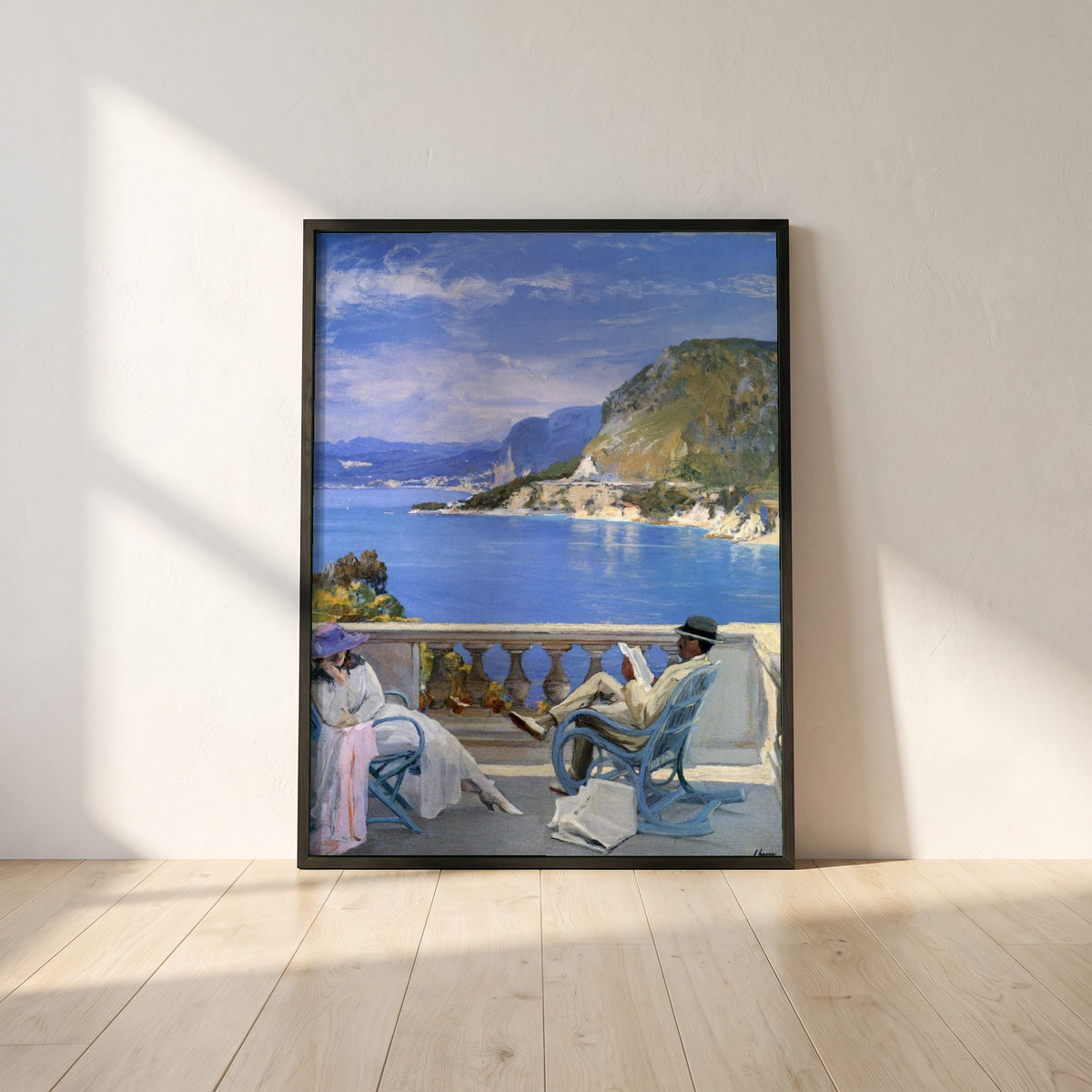 The Honeymoon framed print in a black frame leaning against a white plaster wall on oak floorboards in morning light