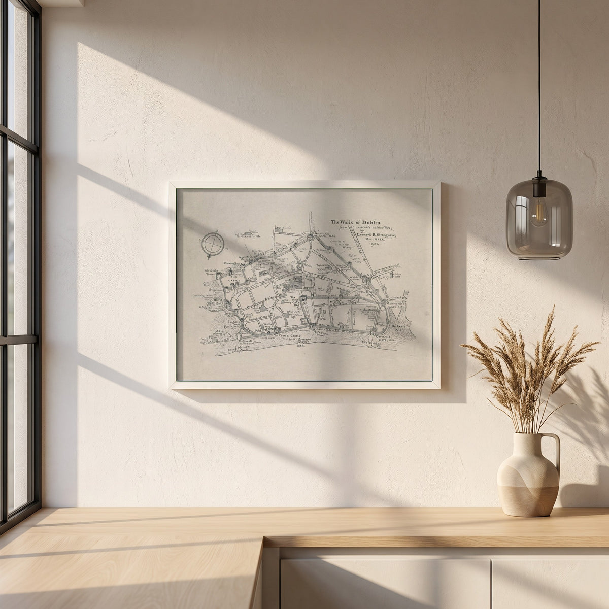 The Walls of Dublin framed print in a white frame on a plaster wall above an oak worktop in a bright Scandinavian kitchen