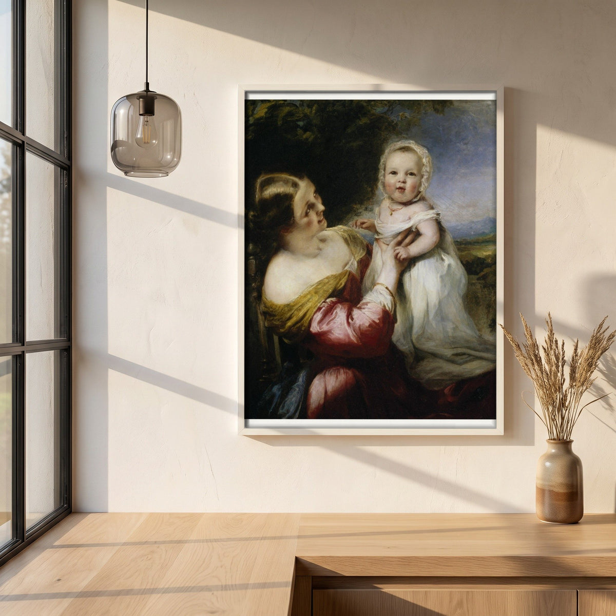 Young Mother's Pastime (1844) framed print in a white frame on a plaster wall above an oak worktop in a bright Scandinavian kitchen