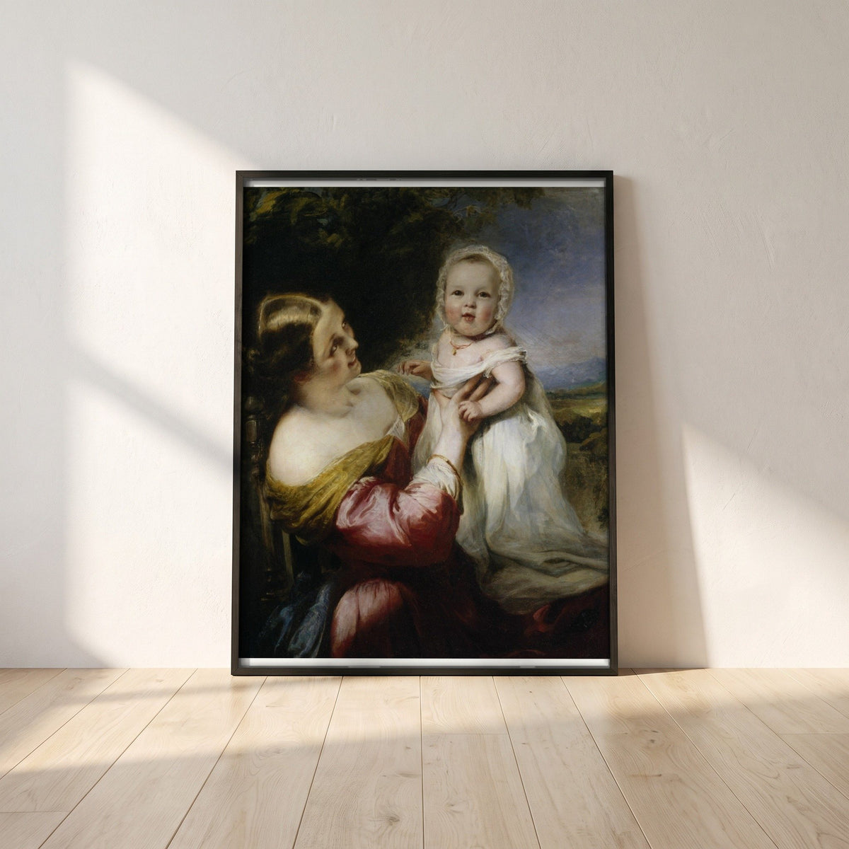 Young Mother's Pastime (1844) framed print in a black frame leaning against a white plaster wall on oak floorboards in morning light